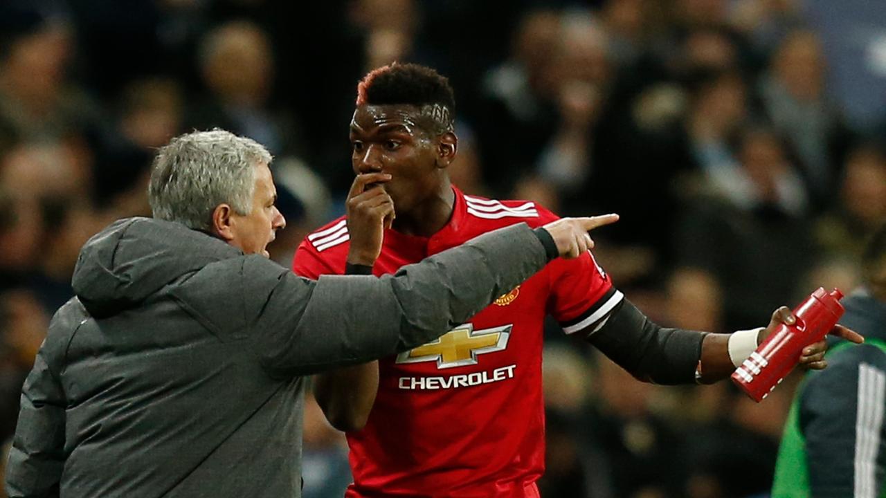 Manchester United's Portuguese manager Jose Mourinho (L) talks with French midfielder Paul Pogba (R).