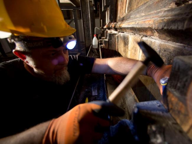 Restoration workers peel back ancient layers surrounding cave said to ...