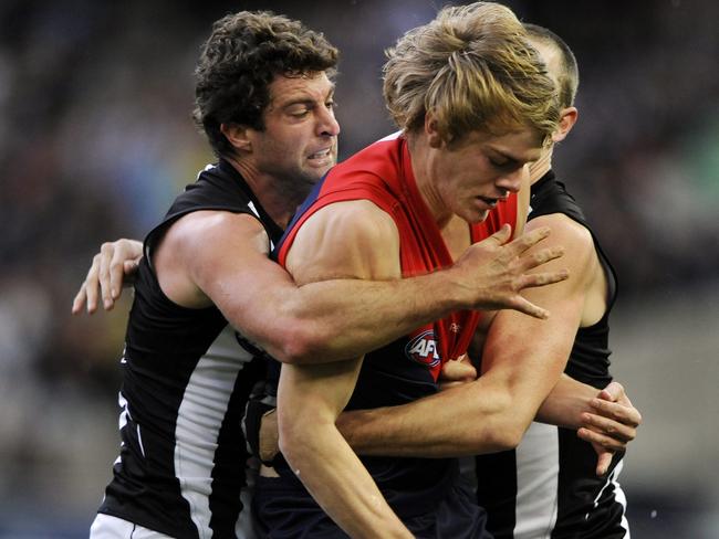 Collingwood v Melbourne. MCG. Jack Watts gets his first touch in AFL as he is tackled by Shane O'Bree and Nick Maxwell. He got a free kick for holding the man.