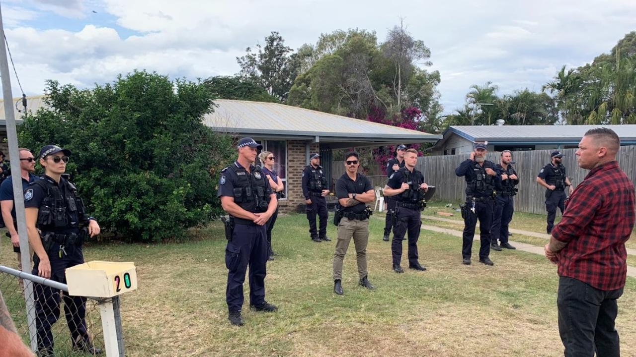 Police guarding a home in Norman Gardens during an anti-crime rally.