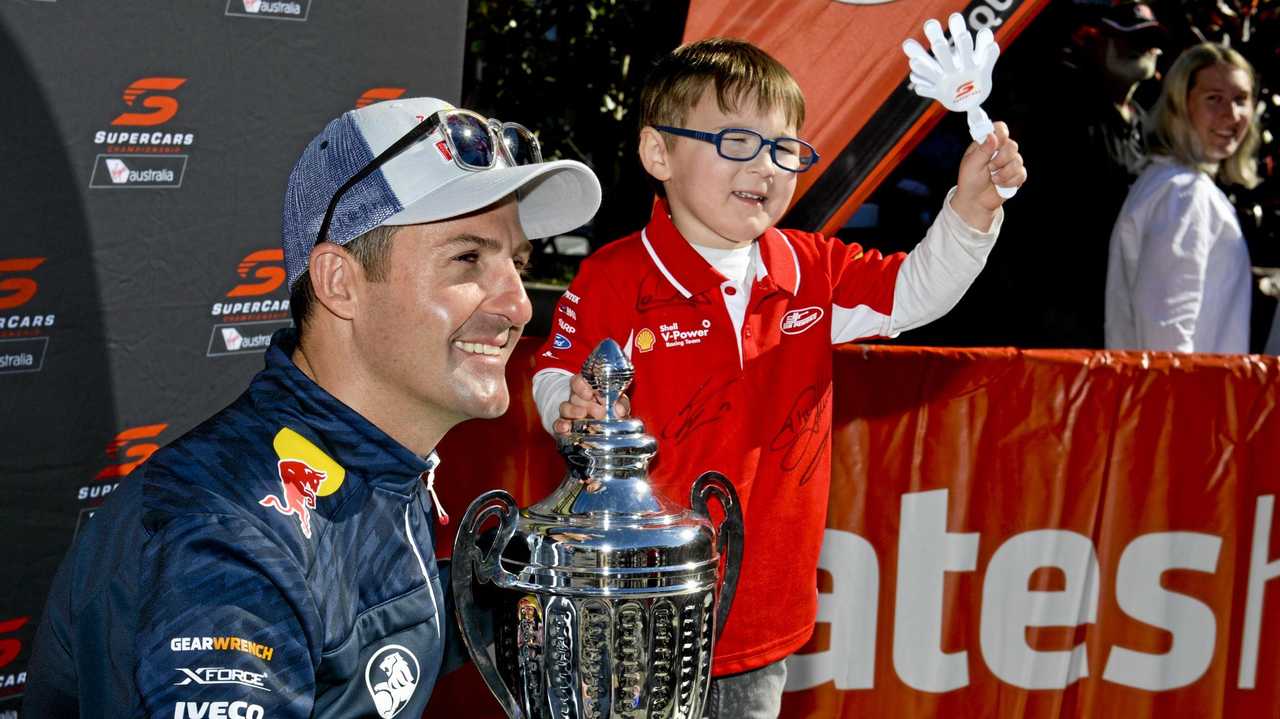 Defending Supercars champion Jamie Whincup meets four-year-old Oliver Emerson-Fay at the Coates Hire Ipswich SuperSprint Community Day. Picture: Cordell Richardson