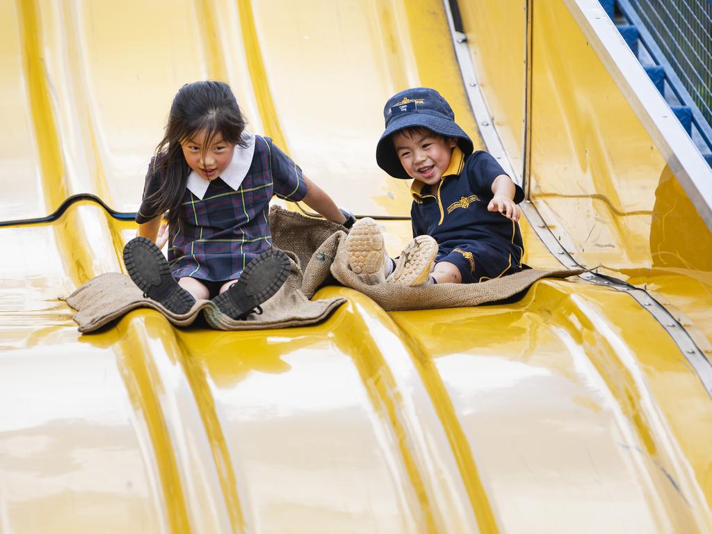 Charlotte and Calvin Ong on the giant slide at the Fairholme Spring Fair, Saturday, October 19, 2024. Picture: Kevin Farmer