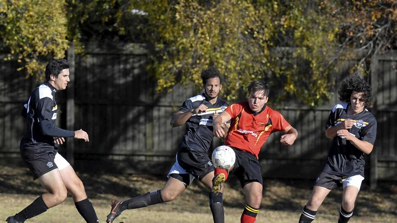 UNDER CONTROL: Gatton Redbacks player Dominic Rosier holds off his West Wanderers opponent. The Redbacks play host to Warwick Wolves tonight. Picture: Kevin Farmer