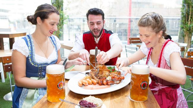 Giulia Treuner, Jeremy Lou Vaggers and Georgie Meredith tuck into a meat platter at The Bavarian in Chatswood.