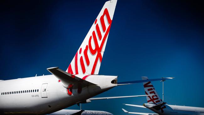 Virgin Australia aircraft are parked on the tarmac at Brisbane International airport on April 21, 2020. Picture: AFP