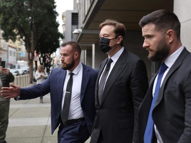 SAN FRANCISCO, CALIFORNIA - FEBRUARY 03: Tesla CEO Elon Musk (C) leaves the Phillip Burton Federal Building on February 03, 2023 in San Francisco, California. Closing arguments have wrapped up in the trial where investors are suing Tesla and Elon Musk, its chief executive officer, over his August 2018 tweets where he said he was taking Tesla private with funding that he secured. The tweet was found to be false and cost shareholders billions of dollars when Tesla's stock price began to fluctuate wildly allegedly based on the tweet.   Justin Sullivan/Getty Images/AFP (Photo by JUSTIN SULLIVAN / GETTY IMAGES NORTH AMERICA / Getty Images via AFP)