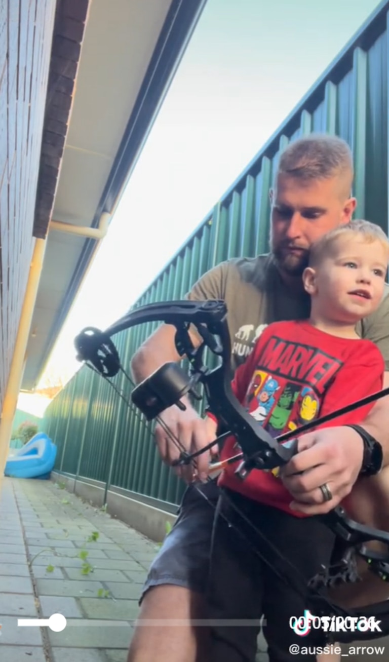 Zach Williams teaching his two-year-old son how to use a bow and arrow. Picture: TikTok / @aussie_arrow