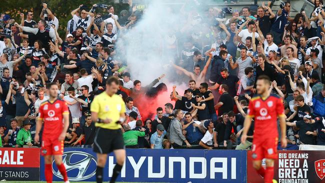Adelaide United v Melbourne Victory at Coopers Stadium. Victory fans celebrate goal with a flare. Photo Sarah Reed.