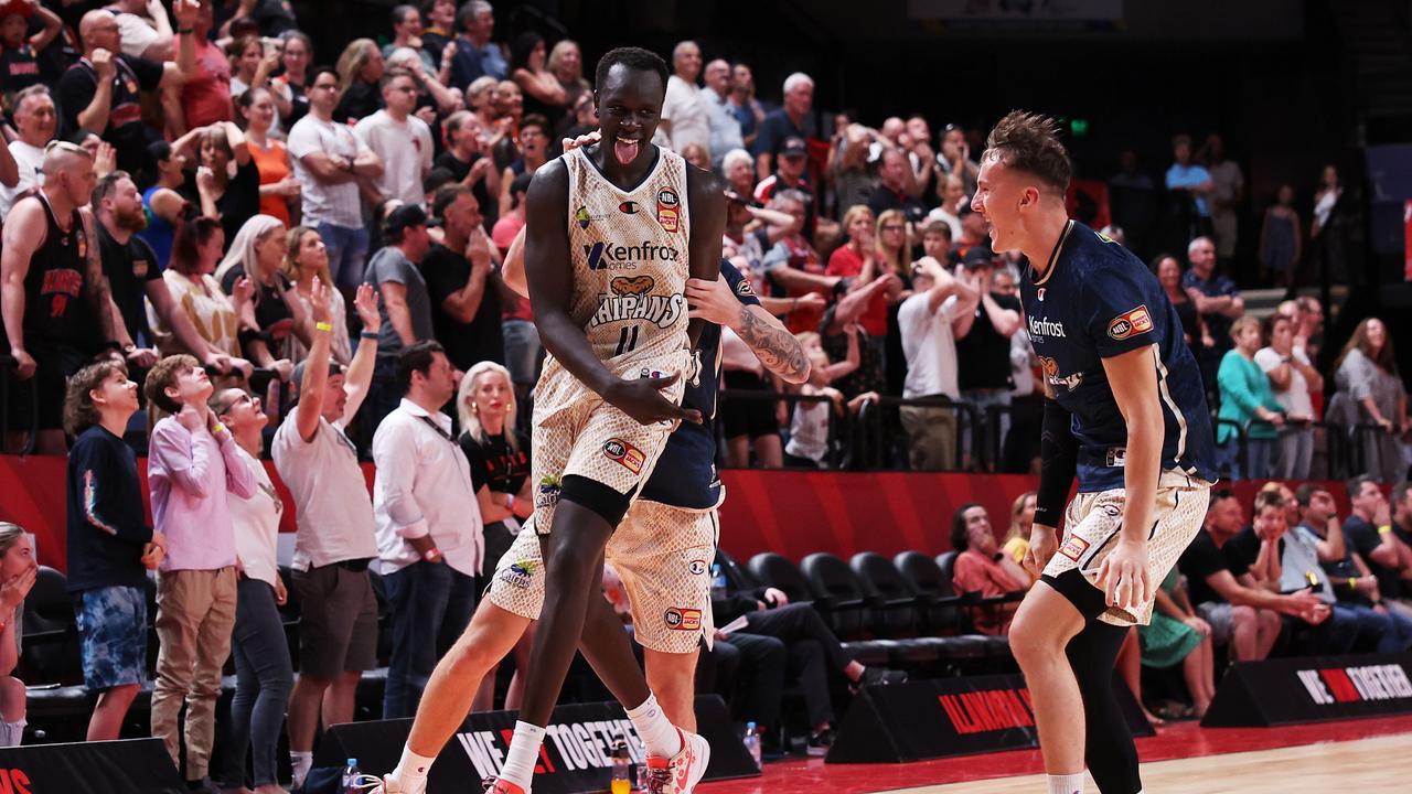 Lat Mayern of the Taipans celebrates victory with teammates after scoring the winning basket against the Illawarra Hawks. Picture: Getty Images