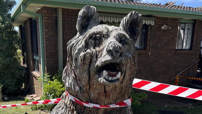 The owners of the burnt down home said they were happy to still have their wooden bear. Picture: Tom McGann