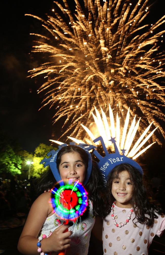 NYE Fun Yarra park. Lauren and Penelope Triandos from Nth Balwyn enjoy the fireworks. Picture: Stuart Milligan