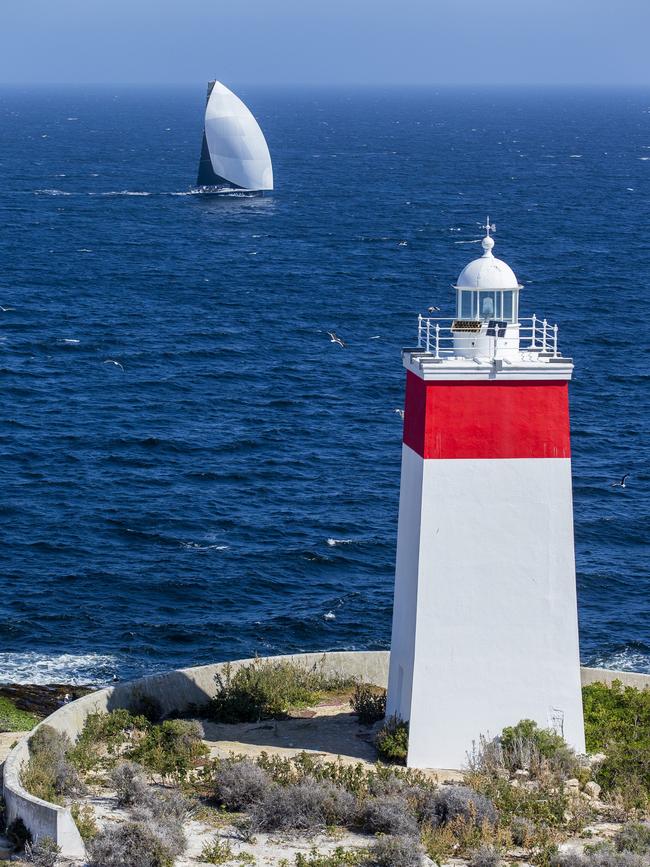 Maxi yacht Naval Group racing past Tasmania’s Iron Pot Lighthouse on the way to the finish line in the Sydney Hobart Yacht Race. Picture: Andrea Francolini/Alea/Getty Images