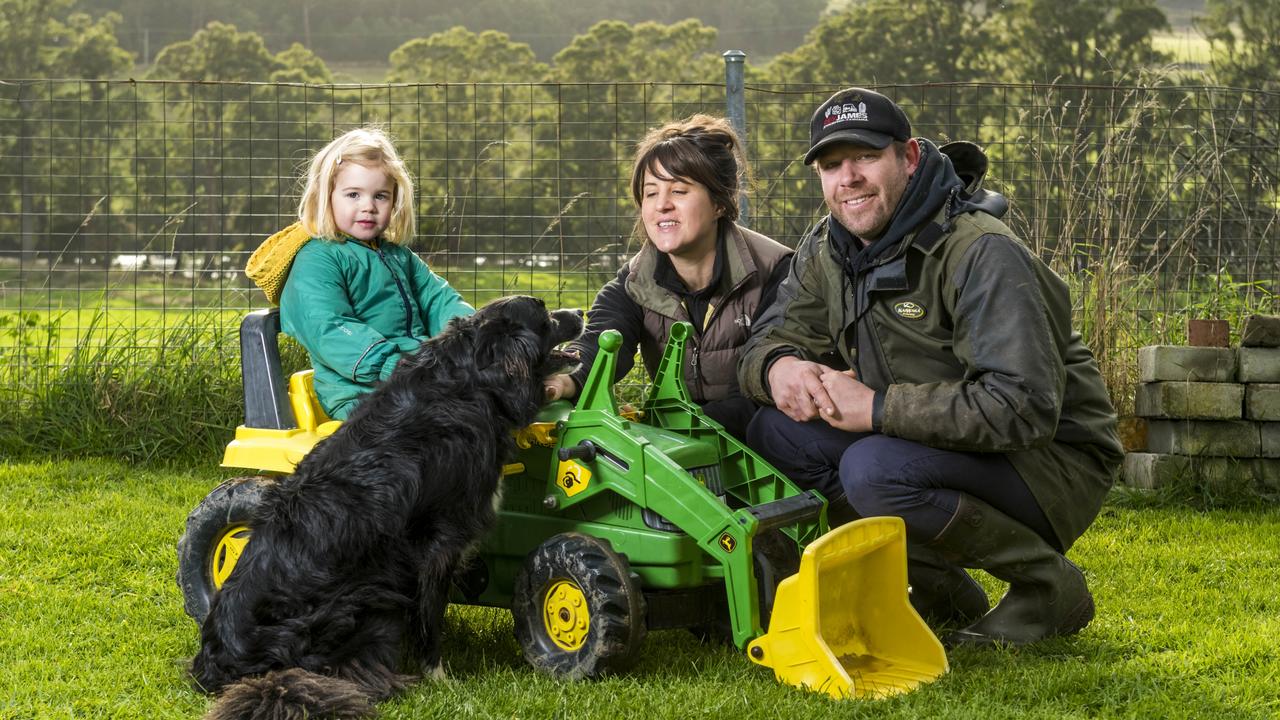 Farm Managers Richard and Karen Butler with 3 year old daughter Imogen, and dog Jono. Picture: Phillip Biggs