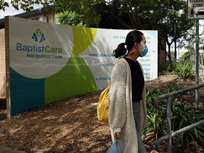 08/03/2020. A woman walks past the Dorothy Henderson Lodge in Marsfield where an elderly resident died of Corona virus last night. Jane Dempster/The Australian.