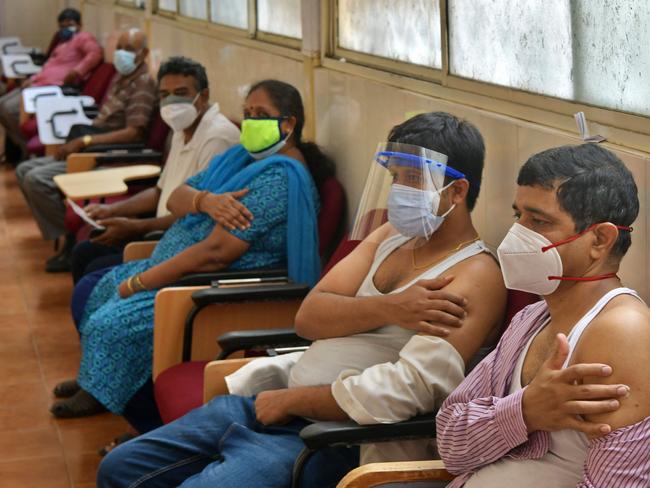 People sit in an observation room after getting a dose of the Covaxin COVID-19 vaccine at a vaccination centre in KC General government hospital in Bangalor. Picture: Manjunath Kiran