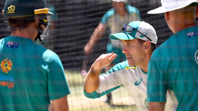 Langer gives tips to Marnus Labuschagne (left) during a training session at Adelaide Oval.