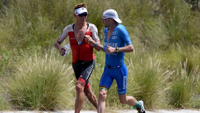 KAILUA KONA, HI — OCTOBER 13: Patrick Lange of Germany passes Cameron Wurf of Australia on the run during the IRONMAN World Championships brought to you by Amazon on October 13, 2018 in Kailua Kona, Hawaii. (Photo by Nils Nilsen/Getty Images for IRONMAN)