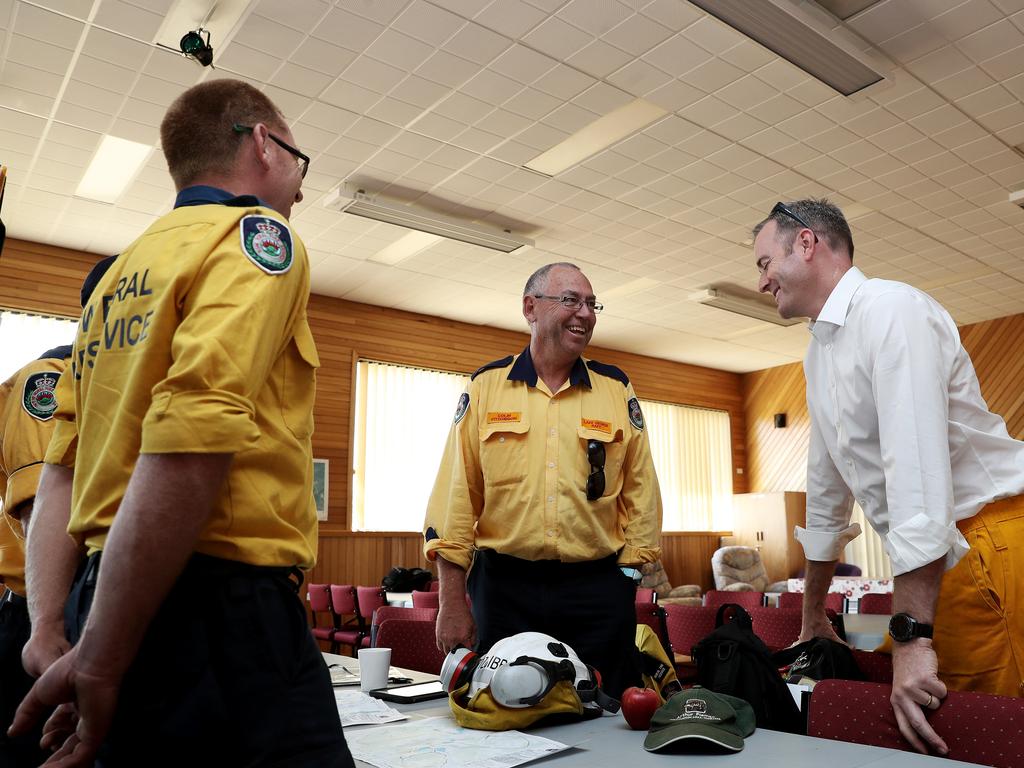 Colin Fitzgibbon (centre) from NSW Rural Fire Service speaks to Police and Emergency Services Minister Michael Ferguson. Picture: LUKE BOWDEN