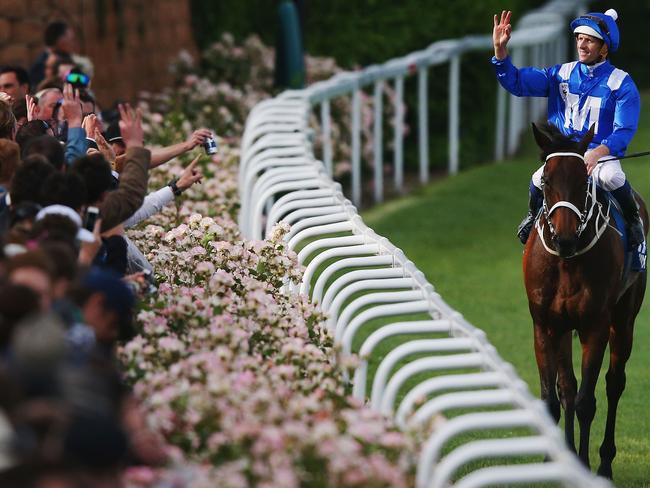 Hugh Bowman celebrates with the crowd after he and Winx combined to win her first of four Cox Plates in 2015. Picture: Michael Dodge/Getty Images