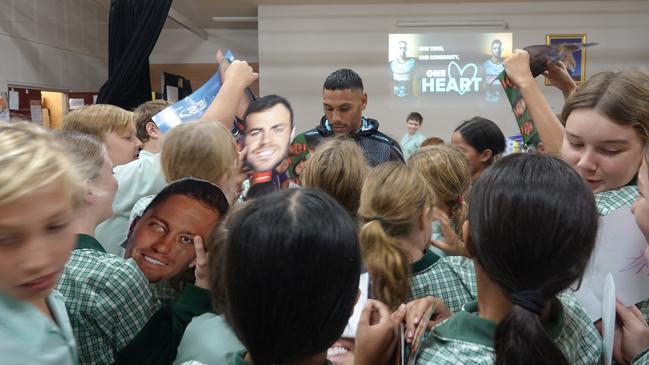 Cronulla Sharks NRL players Jesse Ramienis mobbed during a visit to Mary Help of Christians Primary School at Coffs Harbour. Picture: Chris Knight