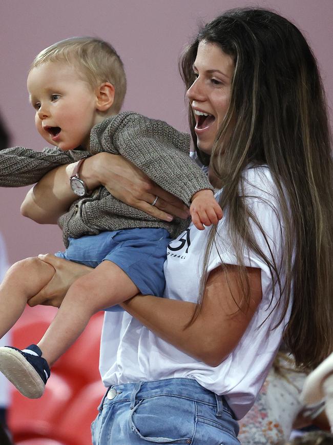 Jordan Ablett and son Levi cheer on dad Gary as the final siren sounds Pic: Michael Klein