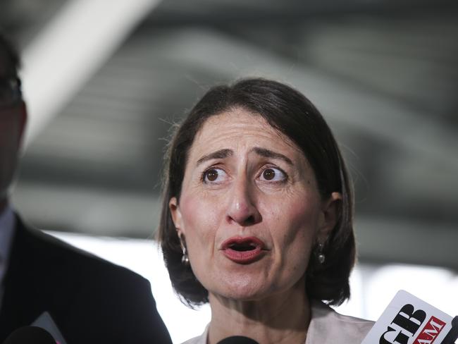 New South Wales Premier Gladys Berejiklian stops at Heathcote train station with New South Wales Treasurer Dominic Perrotet and Heathcote MP Lee Evans during her campaign ahead of the state election on Saturday. Picture: Dylan Robinson