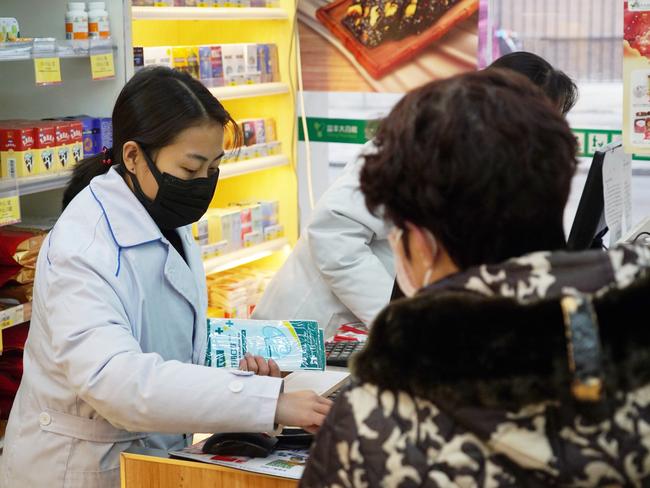 Pharmacies in Wuhan are restricting customers to buying one mask at a time amid high demand and worries over an outbreak of a new coronavirus. Picture: AFP