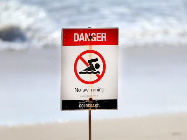 5th February 2021 -  Broadbeach, Gold Coast.   Gold Coast City Council Life Guards  erect ÃBeach Closed - No SwimmingÃ signs after the beach was closed for dangerous surf. Photo: Scott Powick NEWSCORP