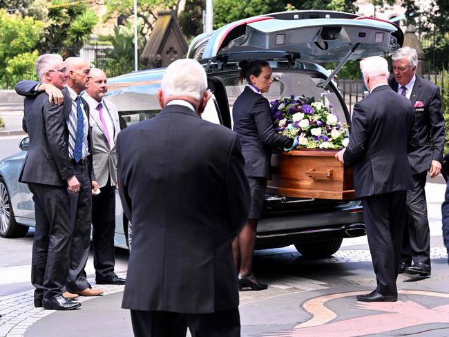 The casket of Australian tennis great Neale Fraser from St Patrick's Cathedral is placed in a hearse after the state funeral for the three-time grand slam winner who died aged 91, in Melbourne on December 18, 2024. (Photo by William WEST / AFP)