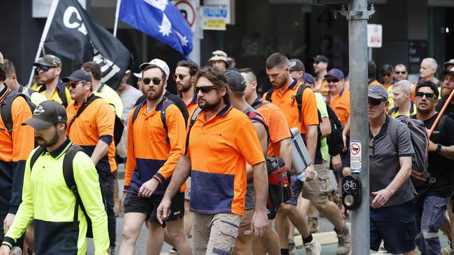 CFMEU workers pictured marching through the streets of Brisbane.