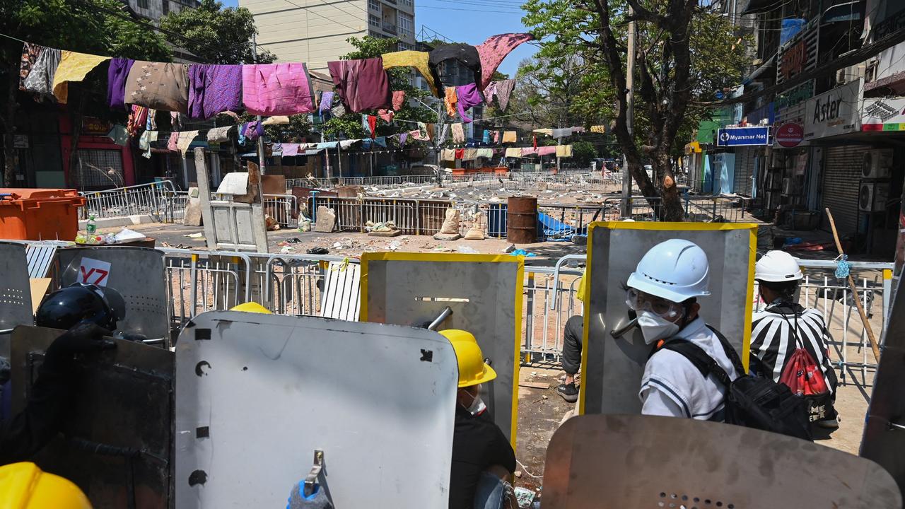 Protesters gather behind shields during a demonstration against the military coup. Picture: STR/AFP