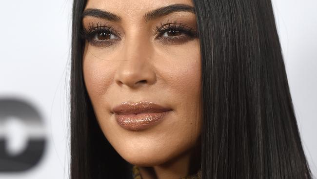 Kim climbs tree completely naked