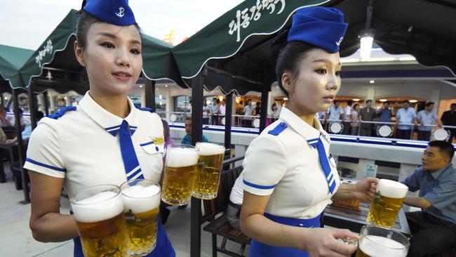 Waitresses serve drinks at North Korea’s first beer festival.
