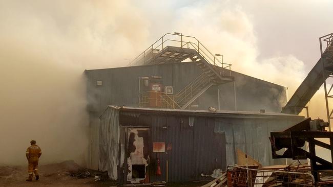 Smokes still surrounds the damaged Ta Ann mill in the Huon Valley.