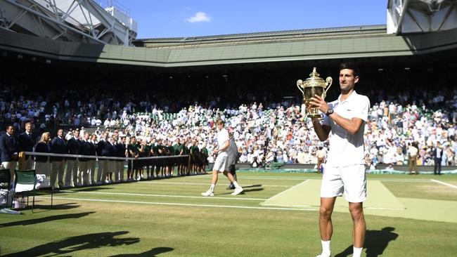 Serbia's Novak Djokovic holds the winners trophy after beating South Africa's Kevin Anderson 6-2, 6-2, 7-6 in their men's singles final match on the thirteenth day of the 2018 Wimbledon Championships at The All England Lawn Tennis Club in Wimbledon, southwest London, on July 15, 2018. / AFP PHOTO / NEIL HALL / RESTRICTED TO EDITORIAL USE