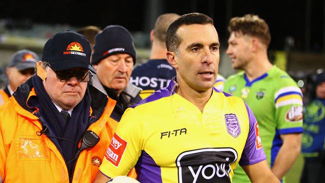 Referee Matt Cecchin is escorted from the field by security after the Raiders-Storm match.