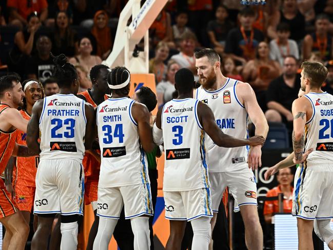 CAIRNS, AUSTRALIA - JANUARY 21: Aron Baynes of the Bullets is held by teammate Shannon Scott during the round 16 NBL match between Cairns Taipans and Brisbane Bullets at Cairns Convention Centre, on January 21, 2024, in Cairns, Australia. (Photo by Emily Barker/Getty Images)