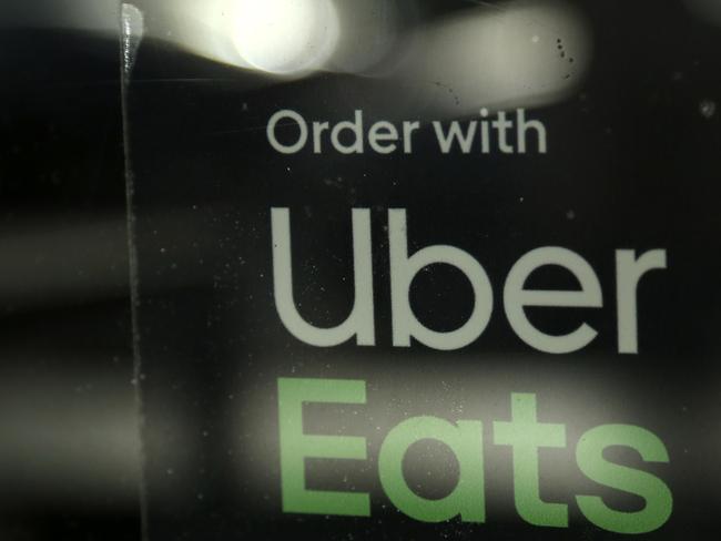 FILE - In this Nov. 6, 2019, file photo, a restaurant advertises Uber Eats in the Coconut Grove neighborhood in Miami. Some app-based delivery companies have announced hiring sprees to cope with a surge in orders from millions of people stuck at home during the coronavirus outbreak. Uber has an internal app that helps its ride-hailing drivers find work for Uber Eats and other jobs. (AP Photo/Lynne Sladky, File)