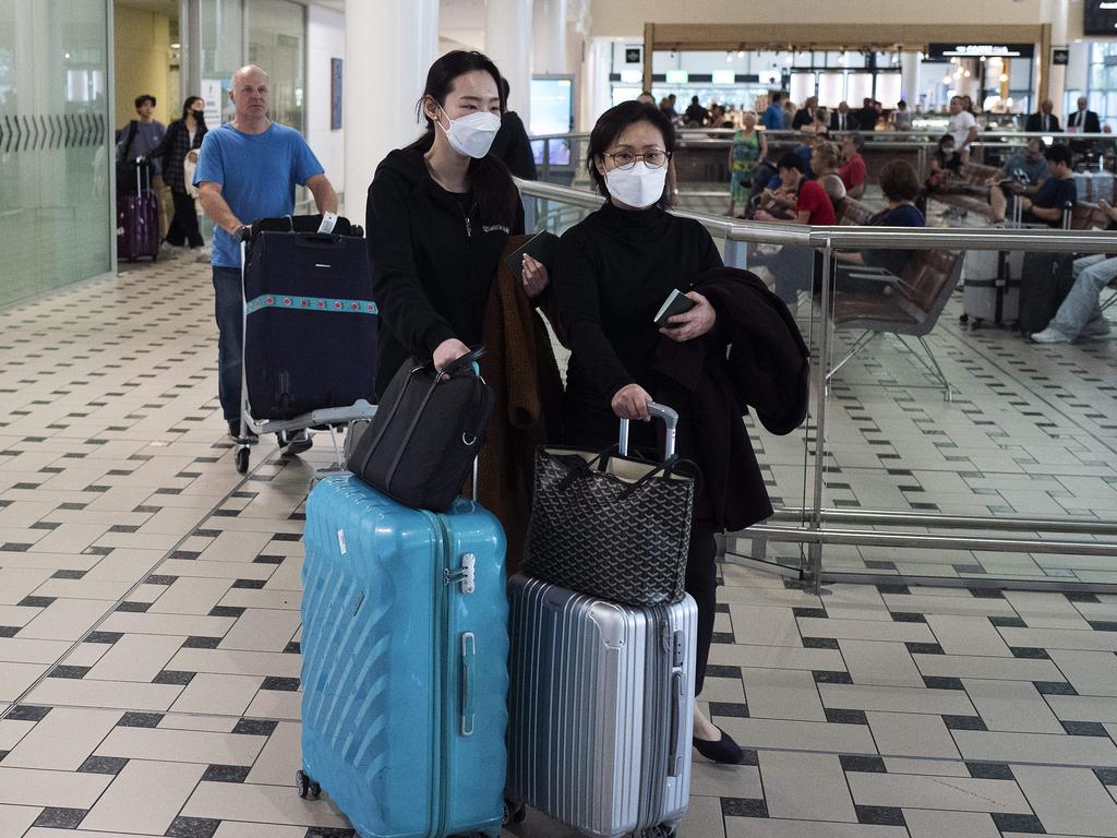 People arriving and wearing mask at the airport. Picture: Attila Csaszar/AAP