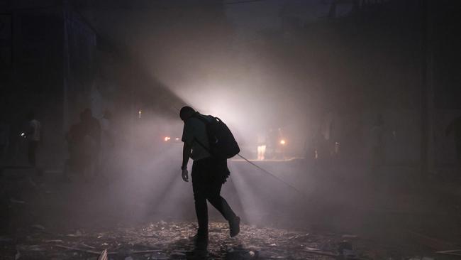 A man finds his way along a debris-strewn street following Israeli air strikes in Gaza City on October 7, 2023. Palestinian militants have begun a "war" against Israel which they infiltrated by air, sea and land from the blockaded Gaza Strip, Israeli officials said, a major escalation in the Israeli-Palestinian conflict. Picture: AFP