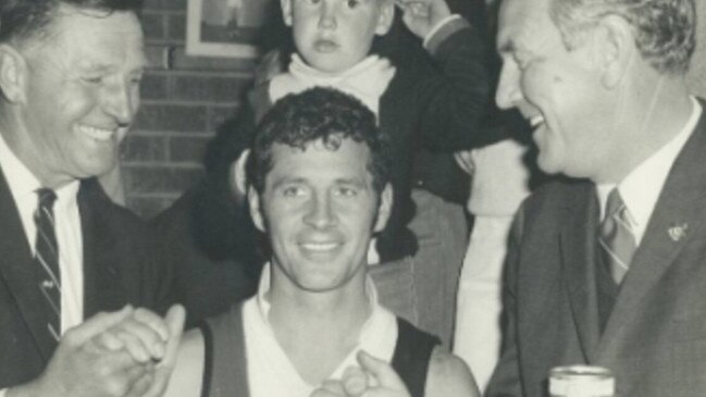 Martin Cross, centre, after playing for Myrtleford in their 1970 grand final win in Ovens and Murray league. Picture: Supplied