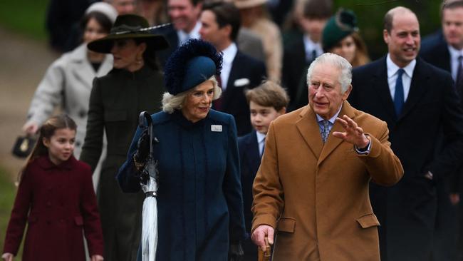 King Charles III and Camilla, Queen Consort wave to members of the public as they arrive for the Royal Family's traditional Christmas Day service at St Mary Magdalene Church in Sandringham, Norfolk. Picture: AFP