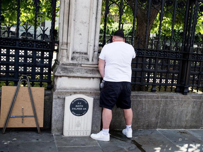 A man urinates on the memorial of heroic policeman Keith Palmer.