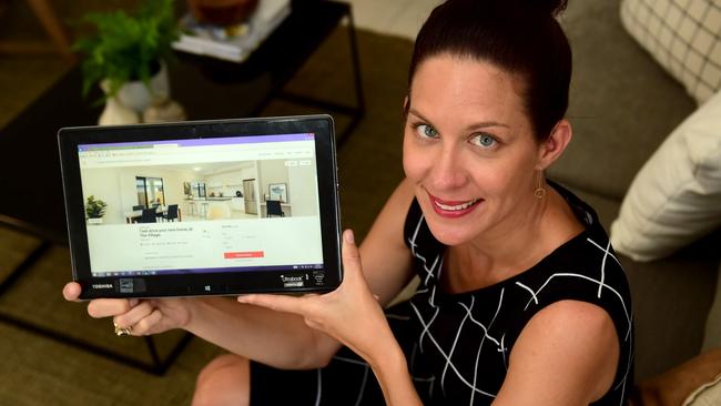 The Village sales professional Rachel Forster with her Airbnb app at the display home.