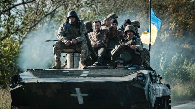 Ukrainian soldiers ride on an armoured vehicle in Novostepanivka, Kharkiv region, on September 19 amid the Russian invasion of Ukraine. Picture: Yasuyoshi Chiba/AFP