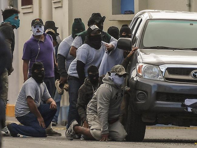 Paramilitaries surround a church on July 9. Picture: Marvin Recinos