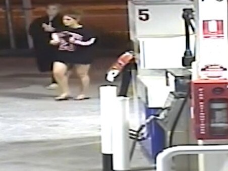 Two women seen walking into the service station.