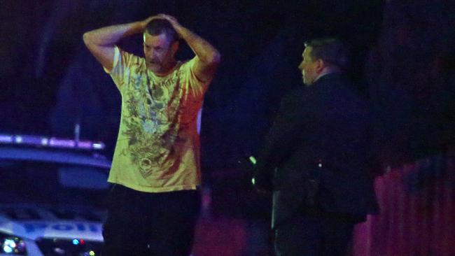 A man talks to police outside a house in Wentworthville where a person has been shot dead. Picture: Richard Dobson