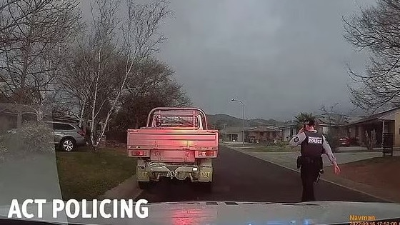 A driver does a burnout in front of police car. Picture: ACT Policing