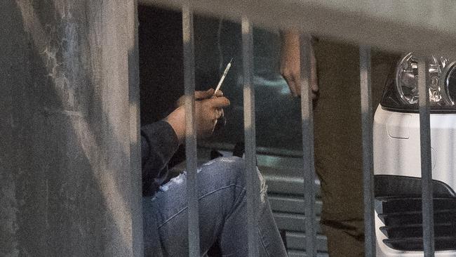 A drug user injects in a car park in Richmond. Picture: JASON EDWARDS